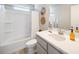 Bright bathroom features a shower-tub combo and stylish vanity with modern fixtures at 13616 E 103Rd Pl, Commerce City, CO 80022