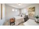 Bright bedroom with natural light, a tufted headboard and contemporary artwork at 13616 E 103Rd Pl, Commerce City, CO 80022