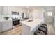 Modern kitchen featuring stainless steel appliances, island with seating, and ample counter space at 13616 E 103Rd Pl, Commerce City, CO 80022