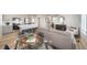 Spacious living area with kitchen island, dining table, and comfortable seating at 13616 E 103Rd Pl, Commerce City, CO 80022