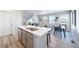 Open floor plan showcasing a kitchen island, dining space, and living room at 13616 E 103Rd Pl, Commerce City, CO 80022