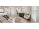 Open living space with wood floors, staircase, and modern furnishings at 13616 E 103Rd Pl, Commerce City, CO 80022