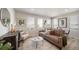 Cozy living room with a couch, side chair, and natural light at 13616 E 103Rd Pl, Commerce City, CO 80022