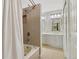 Bathroom with a shower, tub, and dual vanity with white cabinets and neutral tile flooring at 4903 W 73Rd Ave, Westminster, CO 80030