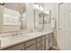 Bathroom featuring double sinks with white quartz countertops, modern lighting, and mirrors at 4903 W 73Rd Ave, Westminster, CO 80030
