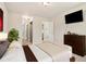 Bright, neutral colored bedroom, showing ensuite bathroom entrance and large flat-screen television at 4903 W 73Rd Ave, Westminster, CO 80030