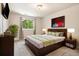 Bright bedroom features a plush rug, sleek wooden furniture, and ample natural light from the window at 4903 W 73Rd Ave, Westminster, CO 80030