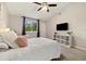 Bright bedroom with a ceiling fan, white bedding, soft furnishings, and a view of the outdoors at 4903 W 73Rd Ave, Westminster, CO 80030