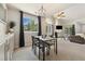 Dining area with large window offering views of the outdoors, next to the cozy living room at 4903 W 73Rd Ave, Westminster, CO 80030