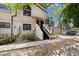 Exterior view of the condo featuring a front entrance with stairs, balcony, and landscaping at 4903 W 73Rd Ave, Westminster, CO 80030