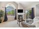Bright living room featuring a fireplace, vaulted ceilings and a large window at 4903 W 73Rd Ave, Westminster, CO 80030