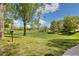 Expansive grassy area with mature trees providing shade and visual appeal to this community green space at 4903 W 73Rd Ave, Westminster, CO 80030
