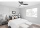 Bright bedroom featuring a ceiling fan, plush bedding, side tables with lamps, and natural light at 1561 W Beekman Pl, Denver, CO 80221