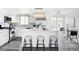 Modern kitchen with white cabinets, quartz countertops, stainless steel appliances, and a kitchen island at 1561 W Beekman Pl, Denver, CO 80221