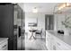 Kitchen with stainless steel refrigerator and breakfast nook with table and chairs at 1561 W Beekman Pl, Denver, CO 80221