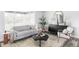 Cozy living room featuring stylish furniture, a decorative mirror, and ample natural light at 1561 W Beekman Pl, Denver, CO 80221