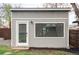 Exterior shot of a modern outbuilding, featuring a window and door at 1561 W Beekman Pl, Denver, CO 80221