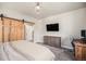 Cozy bedroom with a modern chandelier, wood-style dresser, and dedicated workspace at 15274 W 64Th Ln # 206, Arvada, CO 80007