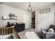 Well-decorated Bedroom featuring a crib, changing table, closet, and a cozy reading chair at 15274 W 64Th Ln # 206, Arvada, CO 80007