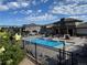 The community pool features lounge seating and a pergola with an outdoor cooking area at 15274 W 64Th Ln # 206, Arvada, CO 80007