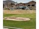 Picturesque golf course view showcasing the clubhouse, sand traps, and well-manicured green at 15274 W 64Th Ln # 206, Arvada, CO 80007