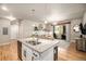 Island kitchen showcases granite countertops, a stainless steel sink, and a seamless transition to the living space at 15274 W 64Th Ln # 206, Arvada, CO 80007