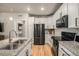 Modern kitchen features granite countertops, sleek black appliances, and efficient cabinet storage solutions at 15274 W 64Th Ln # 206, Arvada, CO 80007