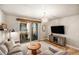 This living room has hardwood floors, a balcony, and custom wooden design elements at 15274 W 64Th Ln # 206, Arvada, CO 80007
