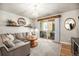 This living room has hardwood floors, neutral colors, and a balcony at 15274 W 64Th Ln # 206, Arvada, CO 80007