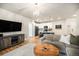 An open-concept living room showcases a decorative chandelier and flows into a modern kitchen at 15274 W 64Th Ln # 206, Arvada, CO 80007
