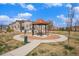 Community park showcasing a covered picnic area with benches, landscaping, and a sidewalk at 15274 W 64Th Ln # 206, Arvada, CO 80007