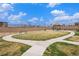Well-maintained community park featuring benches, a covered picnic area, and a walking path at 15274 W 64Th Ln # 206, Arvada, CO 80007