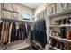 Organized walk-in closet with ample storage, including hanging racks and shelving for shoes and accessories at 15274 W 64Th Ln # 206, Arvada, CO 80007