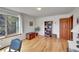 Bright bedroom with wood floors, large window with outdoor views, and stylish decor at 22349 Natsihi Rd, Indian Hills, CO 80454