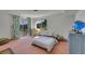 Spacious bedroom with light pink carpet with a sliding glass door providing access to amazing outdoor views at 22349 Natsihi Rd, Indian Hills, CO 80454