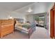 Bedroom boasts a wood-framed bed and dresser with a sliding glass door with scenic views at 22349 Natsihi Rd, Indian Hills, CO 80454