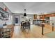 Bright dining area featuring wood floors, modern lighting, and easy access to the kitchen and outdoor patio at 22349 Natsihi Rd, Indian Hills, CO 80454