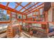 Unique greenhouse interior with hanging chairs, potting bench, and natural light for gardening at 22349 Natsihi Rd, Indian Hills, CO 80454
