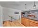 Open kitchen with wooden cabinets and granite counters, with a seamless transition to the living area at 22349 Natsihi Rd, Indian Hills, CO 80454