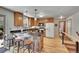 Well-lit kitchen with granite countertops, wooden cabinetry, and a breakfast bar with stool seating at 22349 Natsihi Rd, Indian Hills, CO 80454