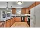 Bright kitchen featuring granite countertops, stainless steel appliances, and a view of the natural landscape at 22349 Natsihi Rd, Indian Hills, CO 80454
