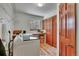 Functional laundry room with a large countertop, storage space, and modern washer, and wooden doors at 22349 Natsihi Rd, Indian Hills, CO 80454