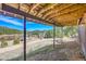 Covered patio boasting mountain views, rustic charm, and a cozy place to relax outdoors at 22349 Natsihi Rd, Indian Hills, CO 80454