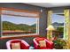 A tranquil window view from a sitting area with comfy red chairs, perfect for relaxation and nature views at 22349 Natsihi Rd, Indian Hills, CO 80454