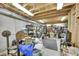 Unfinished basement storage area with exposed ceiling and shelving filled with assorted items at 22349 Natsihi Rd, Indian Hills, CO 80454