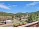 A panoramic mountain view captured from a charming deck with decorative flower boxes at 22349 Natsihi Rd, Indian Hills, CO 80454