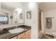 Bright bathroom featuring a vanity with granite counter, an art piece, and a shower/tub combo at 1151 N Marion St # 104, Denver, CO 80218