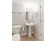 Bathroom featuring a pedestal sink, toilet, tile flooring, and modern lighting at 1151 N Marion St # 104, Denver, CO 80218