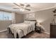 Comfortable bedroom with a ceiling fan, neutral walls, and stylish decor at 1151 N Marion St # 104, Denver, CO 80218