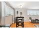 Bright dining area featuring wood floors, a stylish table with stools, and large windows for natural light at 1151 N Marion St # 104, Denver, CO 80218